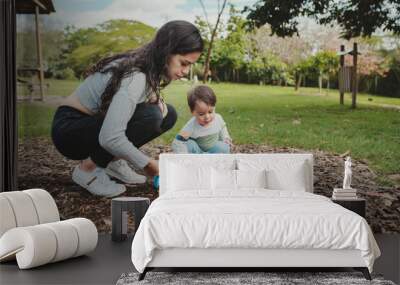 Young mother playing with her young son Wall mural