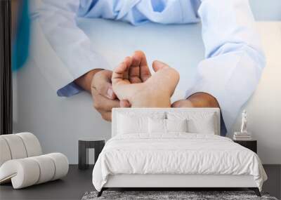 Doctor in white gown or uniform did examination on patient's hand or wrist at hospital.Orthopedist holding woman's hand.Doctor care patient with pain problem in orthopedic unit.Asian man. Wall mural