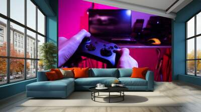 gamer playing game by joystick with computer, gaming and esports challenge, streaming online, tournament concept Wall mural