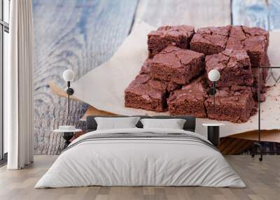 Pieces of freshly baked chocolate brownie on rustic wooden board Wall mural