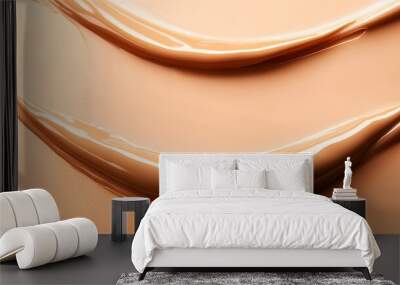 A close-up of the texture and color of liquid foundation, in a light beige color, a smooth cream on an isolated background Wall mural