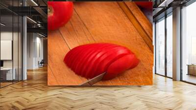 Red ripe tomato, sliced, wooden kitchen Board. Wall mural