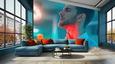 A man in a white shirt is holding his throat in pain, standing in a hospital room. He is looking away from the camera, with a pained expression on his face. Wall mural