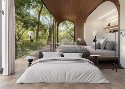 A modern bedroom with a bed, two chairs, a wooden floor, and a large window overlooking a forest. Wall mural