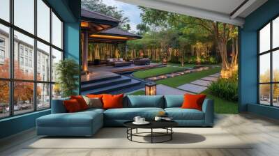 A patio with a pathway leading to a lush green garden with a modern design and warm lighting at night. Wall mural