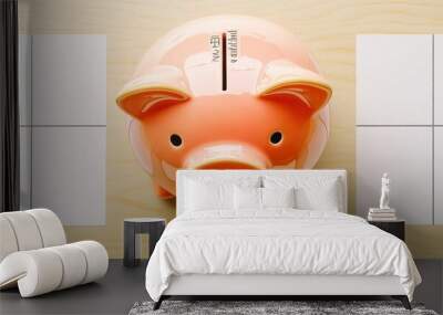 A piggy bank sits between two sheets of paper, representing a choice between saving and spending. Wall mural