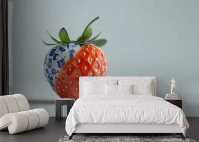 A single red strawberry with blue and white floral designs on one side against a white background. Wall mural