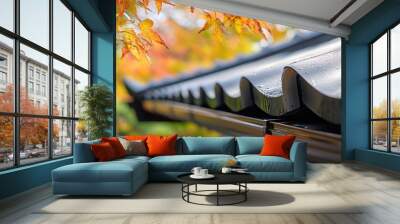 Close-up of a wet roof with fall leaves in the background. Wall mural