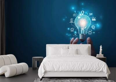 Light bulb with innovation icons in businessman’s hand. Concept of business creativity and solutions. Wall mural