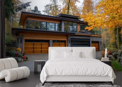 Modern home with a three-car garage and a balcony overlooking the autumn forest. Wall mural