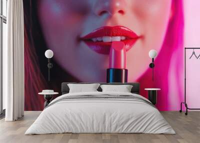 Woman's lips with red lipstick and a tube of lipstick in her hand. Wall mural