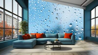 Water droplets on glass with a clear blue sky in the background. Wall mural