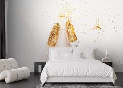 champagne glasses and scattered confetti on a white background. new year holiday concept Wall mural