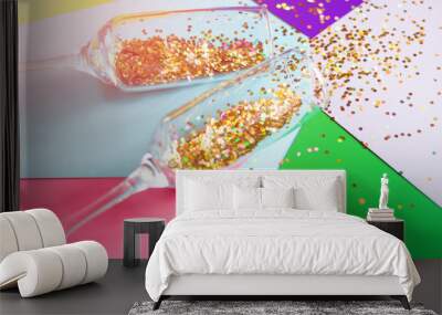 champagne glasses with confetti on a colored background close-up holiday concept Wall mural