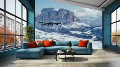 A drone is flying over a snowy mountain range Wall mural