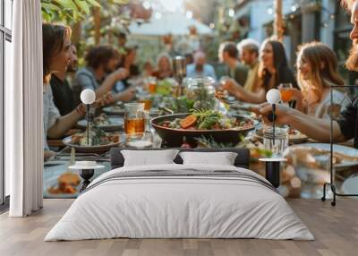 A group of people are gathered around a long table with food and drinks Wall mural