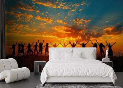 A group of people are holding hands in a field at sunset Wall mural