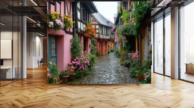 A narrow street lined with colorful houses and flower boxes Wall mural