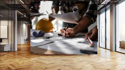 Architect team working with blueprints for architectural plan, engineer sketching a construction project, green energy concept Wall mural