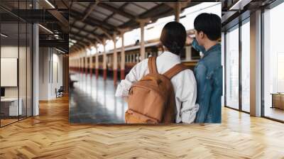 Asian couple at railway station have happy moment. Tourism and travel in the summer Wall mural