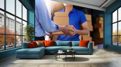 Asian Man hand accepting a delivery boxes. delivery logistic concept Wall mural