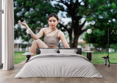 Asian woman wearing sportwear doing Yoga exercise in the nature Wall mural