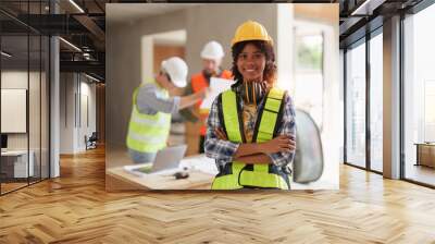 Foreman builder woman at construction site. American African foreman construction standing at construction site Wall mural