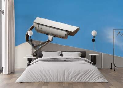 closed circuit tv surveillance camera against a light blue sky Wall mural