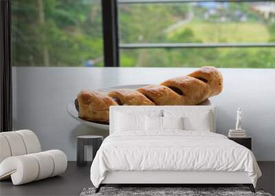 Chicken sausage bun in white dish on table Wall mural