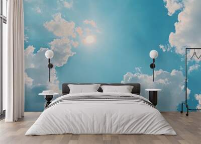 A serene blue sky filled with fluffy, white clouds gently drifting, casting soft shadows on the ground below Wall mural