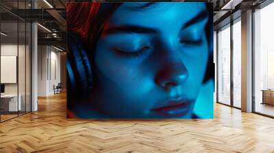 A woman wearing headphones is looking at the camera Wall mural