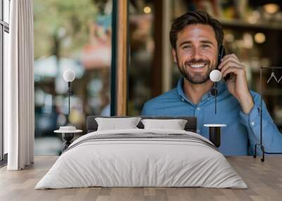 a handsome, smiling man in a blue shirt talking on the phone, with a blurred background of glass windows and a storefront,generative ai Wall mural