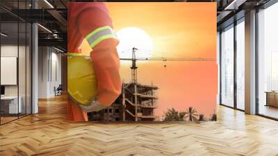 Engineer holding helmet at construction site,safety concept Wall mural