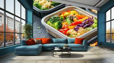 Colorful healthy meal options in take-out containers, on a rustic table. Wall mural