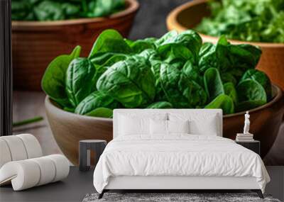 wooden bowl with fresh spinach leaves on dark rustic wooden background. vegan food lifestyle concept Wall mural