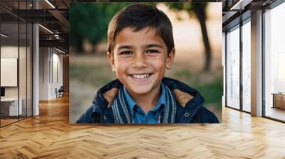 A smiling Tajik boy 5 years old beams with happiness, enjoying the beauty of a sunny day outdoors. His cheerful expression reflects moment of pure joy and innocence. Happy smiling child. AI generated Wall mural