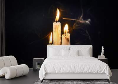 Group of white candles burning in the dark Wall mural