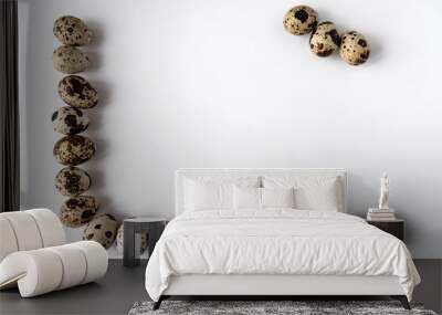 frame of quail eggs on perimeter of two sides on white background. Three eggs in the corner. Copy space Wall mural