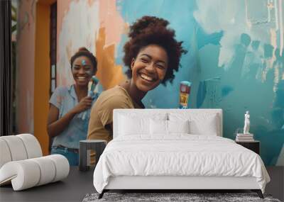 Happy black couple people paint wall outdoors together, painting brush at home. Man and woman make repair. Renovation and decoration house Wall mural