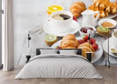 Continental breakfast table with coffee, orange juice, croissants Wall mural