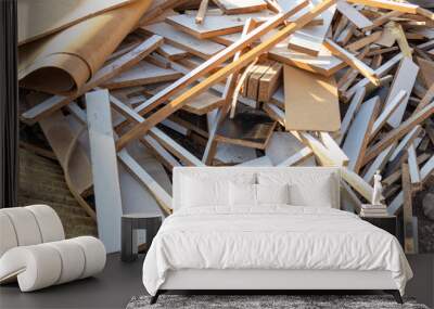 Pile of construction waste, including white and brown wooden debris, pieces of plywood, and old insulation materials. Wall mural