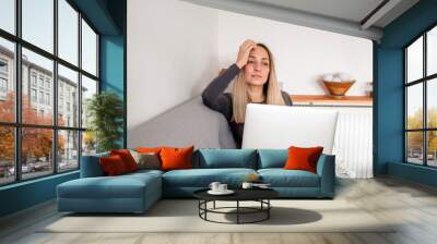 Woman works behind a laptop. Internet business. Freelance girl. Remote work. Modern lifestyle, working day. Mobile device. Type on the keyboard Wall mural