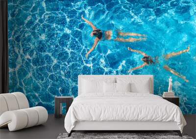 Aerial top view of girls in swimming pool water from above, active children swim, kids have fun on tropical family vacation, holiday resort concept
 Wall mural