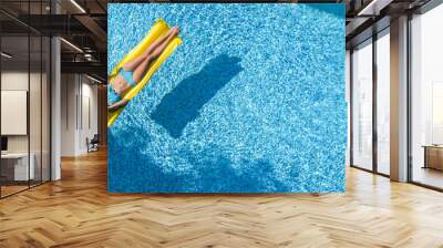 Beautiful young girl relaxing in swimming pool, woman swims on inflatable mattress and has fun in water on family vacation, tropical holiday resort, aerial drone view from above
 Wall mural