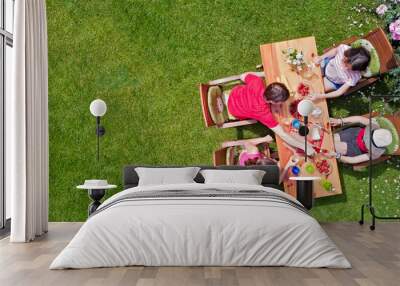 Family and friends eating together outdoors on summer garden party. Aerial view of table with food and drinks from above. Leisure, holidays and picnic concept
 Wall mural