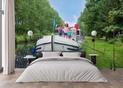 Family vacation on houseboat, summer holiday travel on barge boat in canal, happy kids and mother having fun on river cruise trip in France Wall mural