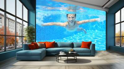 Happy girl swims in pool underwater, active kid swimming Wall mural