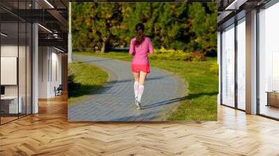 Woman running in autumn park, beautiful girl runner jogging outdoors, training for marathon, exercising and fitness concept
 Wall mural