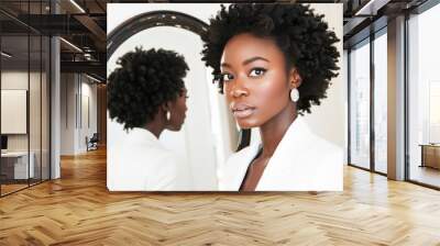 Сonfident young black woman in blazer with natural hair in front of mirror after applying makeup Wall mural