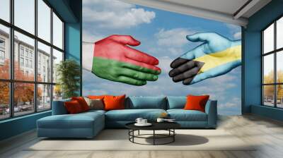 Bahamas and Madagascar country handshaking with flags, consensus concept international co-operation illustration Wall mural